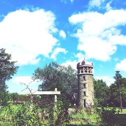 Low angle view of tower against cloudy sky