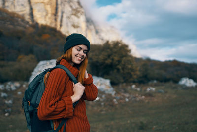 Young woman wearing hat standing outdoors