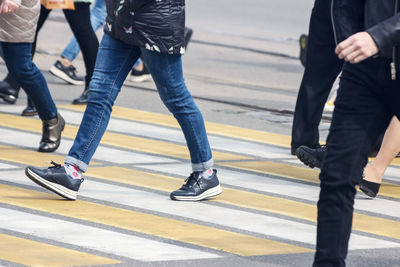 Low section of people walking on road