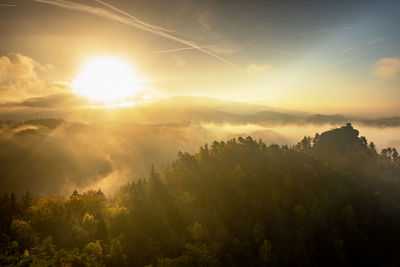 Bohemian switzerland park, czech republic, autumn landscape with fog, orange mist in autumn land