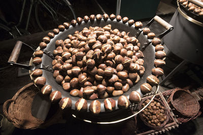 A chestnut vendor roasting chestnuts, delicious edible nuts with brown shell