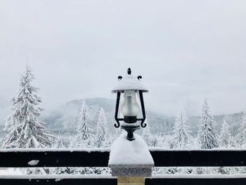 Snow covered land against sky