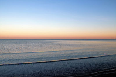 Scenic view of sea against clear sky at sunset