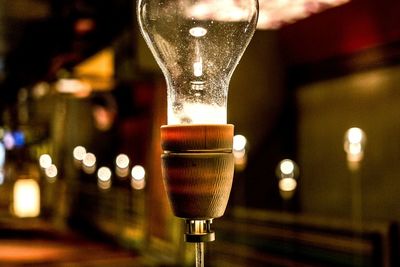 Close-up of illuminated light bulb at night