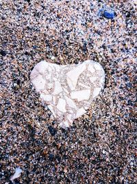 Close-up of heart shape on sand