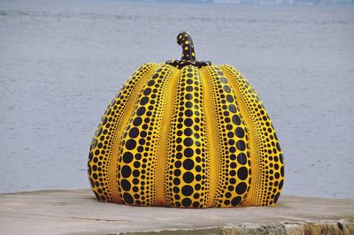 Close-up of yellow umbrella on beach