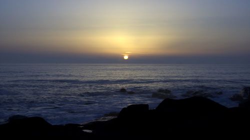 Scenic view of sea at sunset