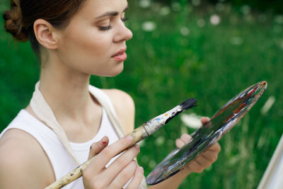 Close-up of young woman playing violin