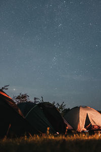 Tent on field against sky at night