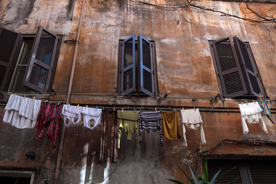 Low angle view of clothes drying on old building