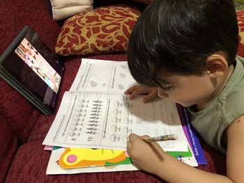 High angle view of boy reading book