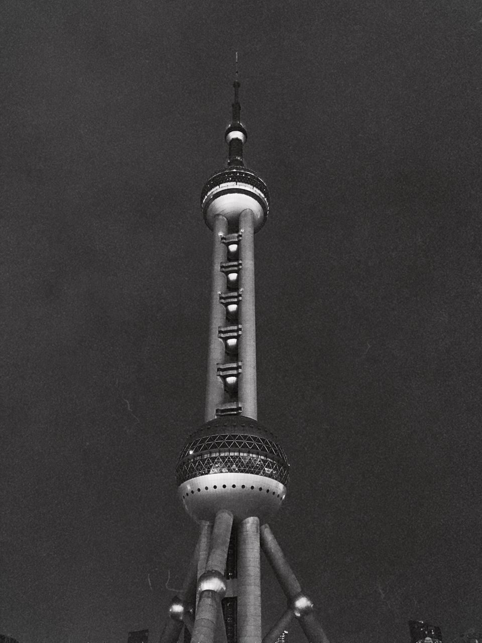 LOW ANGLE VIEW OF COMMUNICATIONS TOWER AGAINST BUILDING