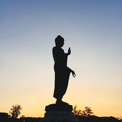 Low angle view of people at sunset