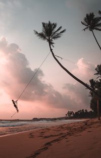 Scenic view of silhouette beach against sky during sunset