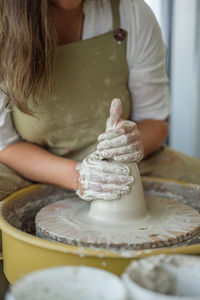 Woman making pottery on the wheel