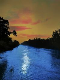 Scenic view of lake against romantic sky at sunset