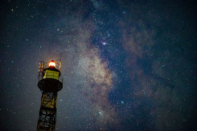 Low angle view of illuminated tower against sky at night