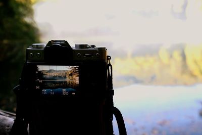 Close-up of camera against the sky