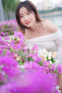 Portrait of smiling young woman with bouquet