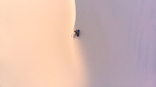 People in desert against sky