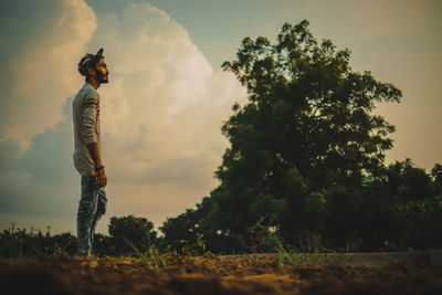 Man standing on field against sky