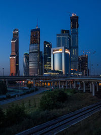 Skyscrapers in city at dusk