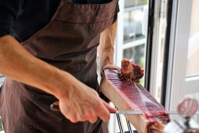 Midsection of man preparing food