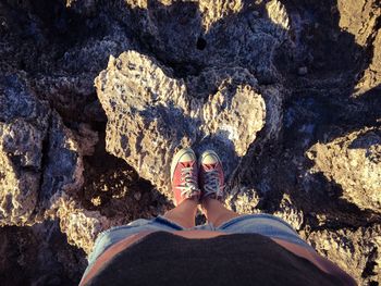 Low section of woman standing on rock