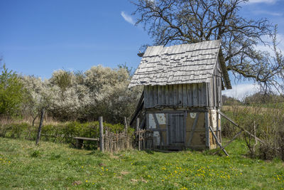 Medieval wooden hut in sunny ambiance at early spring time