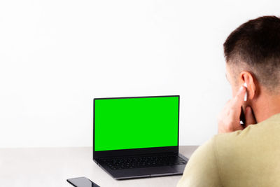 Man using mobile phone against white background