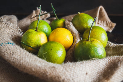 Close-up of oranges in sack on table