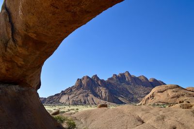 Scenic view of mountains against clear blue sky