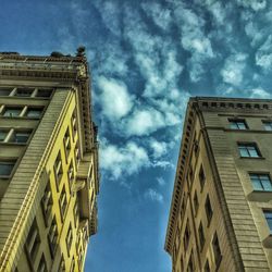 Low angle view of building against cloudy sky