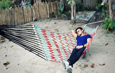 Portrait of young woman sitting on hammock