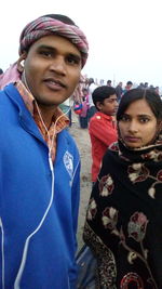 Portrait of young couple standing outdoors