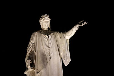 Low angle view of statue against black background