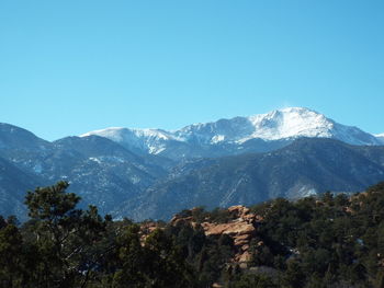 Scenic view of mountains against clear blue sky