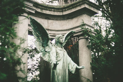 Low angle view of statue against trees