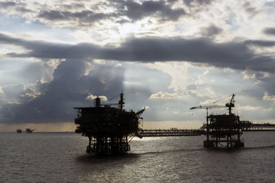 Silhouette of an oil production platform during sunset at offshore terengganu oil field