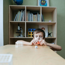 The child plays table football on the desk. speech therapy game for the development of breathing