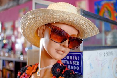 Close-up of mannequin with hat and sunglasses