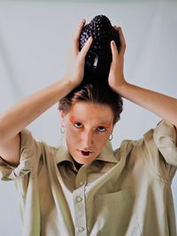 Portrait of young man holding camera