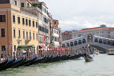 View of boats in canal along buildings