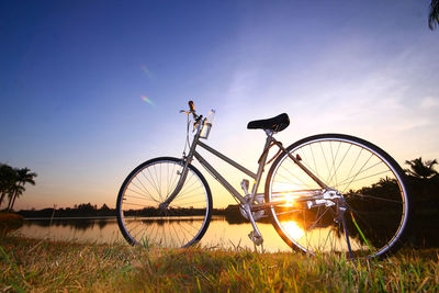 Silhouette bicycle against sky at sunset