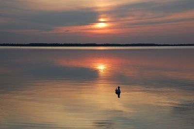 Scenic view of lake against orange sky