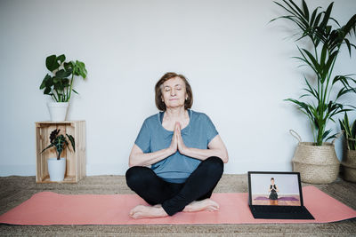 Portrait of woman doing yoga at home
