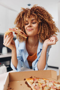 Portrait of young woman having food