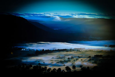 Scenic view of landscape against sky at night