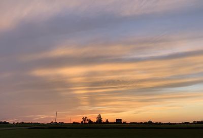 Scenic view of field against sky during sunset