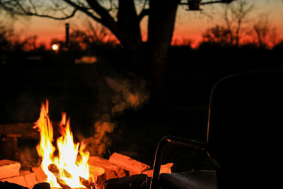 Fire pit and chair in back yard